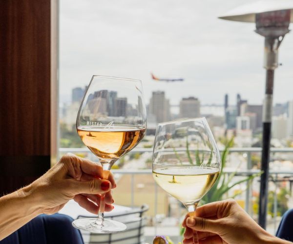 wine glass cheers as a plane flies by in the background