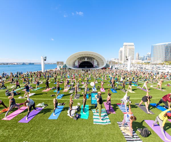 Crowd doing yoga at the Rady Shell at Jacobs Park in San Diego