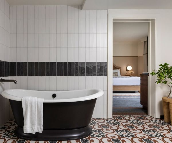 inside of a luxury hotel room with a bed and bathtub