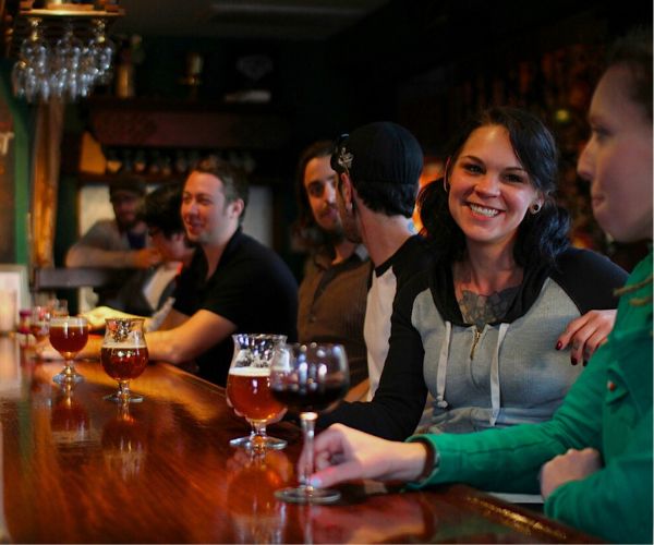 a group of people sitting at a bar