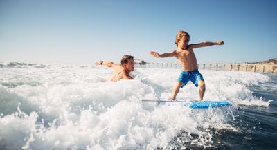 Dad and Son playing in the ocean - Water Activities and Things to Do in San Diego, California
